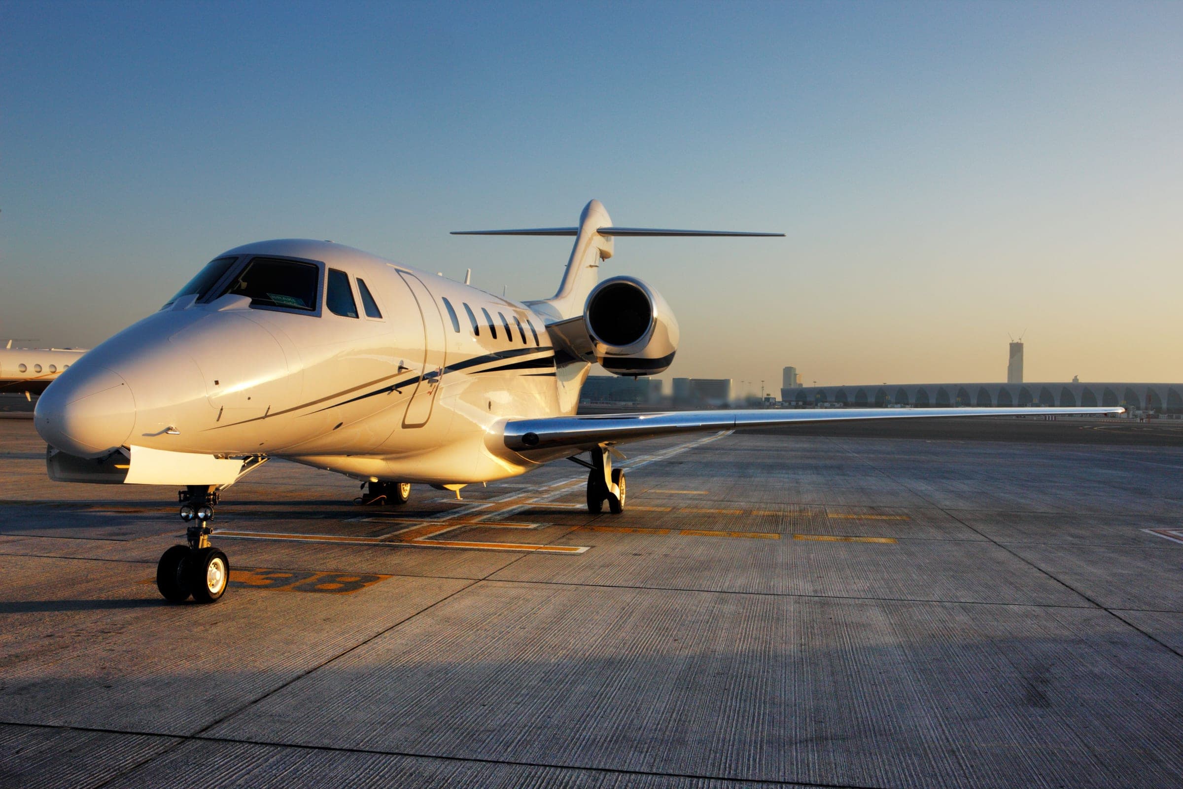 A business jet on the ramp at golden hour